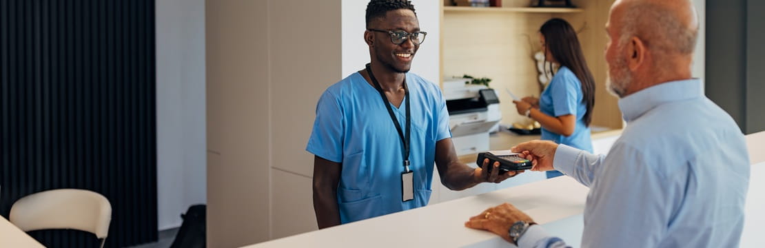 Person paying for a medical service, illustrating how a Health Savings Account can be used to invest for retirement and help cover healthcare costs that Medicare does not.